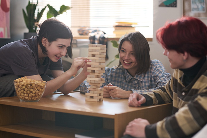 group of gen z individuals playing a board game