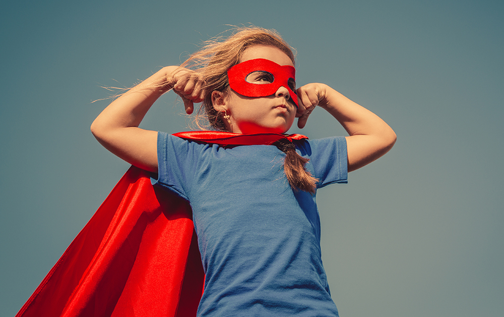 stock image of kid wearing superhero costume