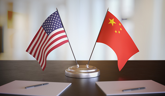 united states and china flags sitting on a table